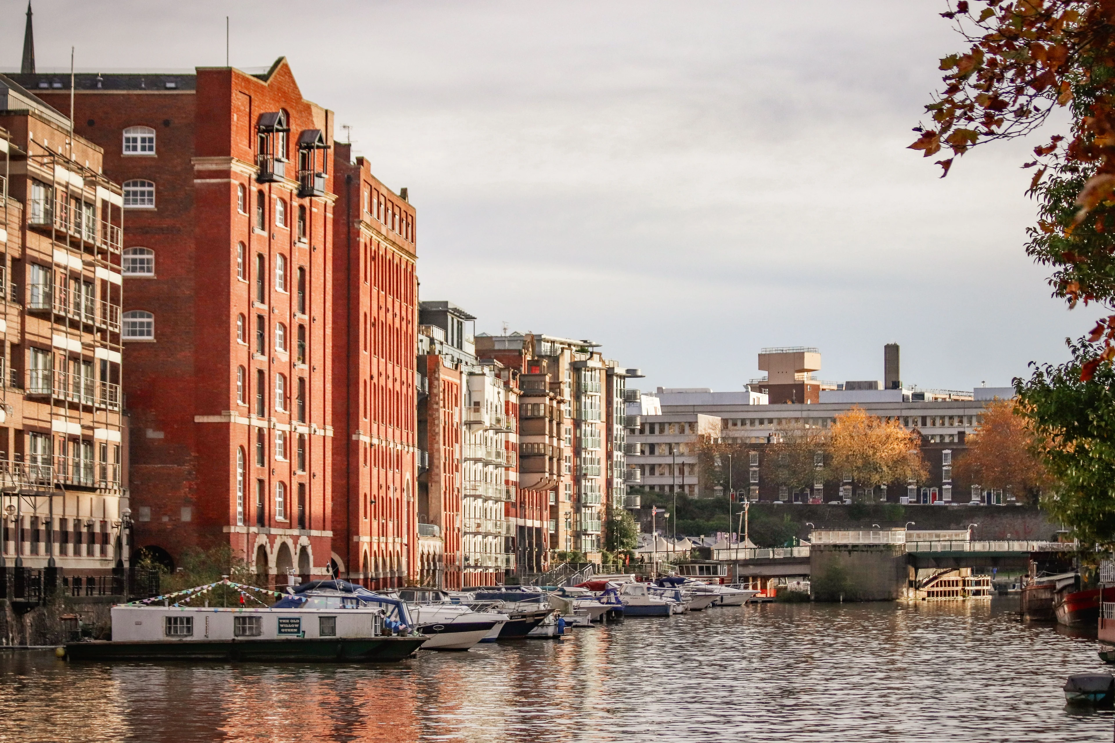 Bristol’s Floating Harbour with historic red-brick buildings and moored boats along the waterside