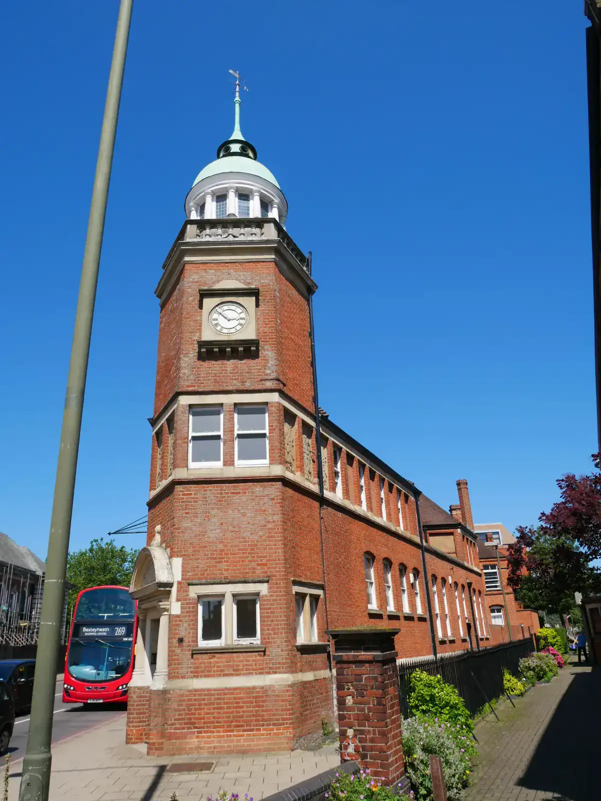 The brick clock tower of Bromley Central Library on the street in Bromley