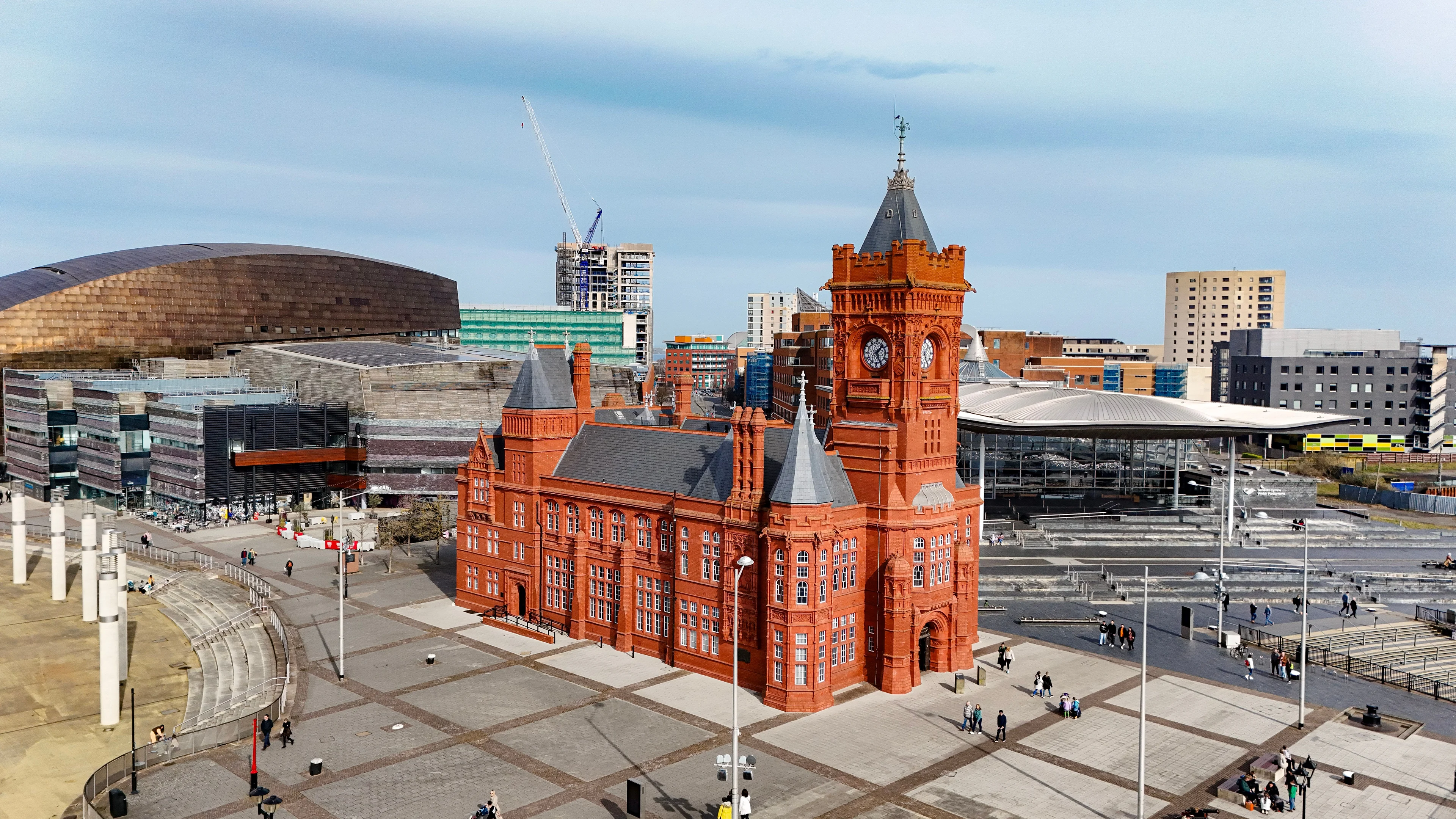 The red-brick Pierhead Building in Cardiff Bay with the Wales Millennium Centre and surrounding buildings