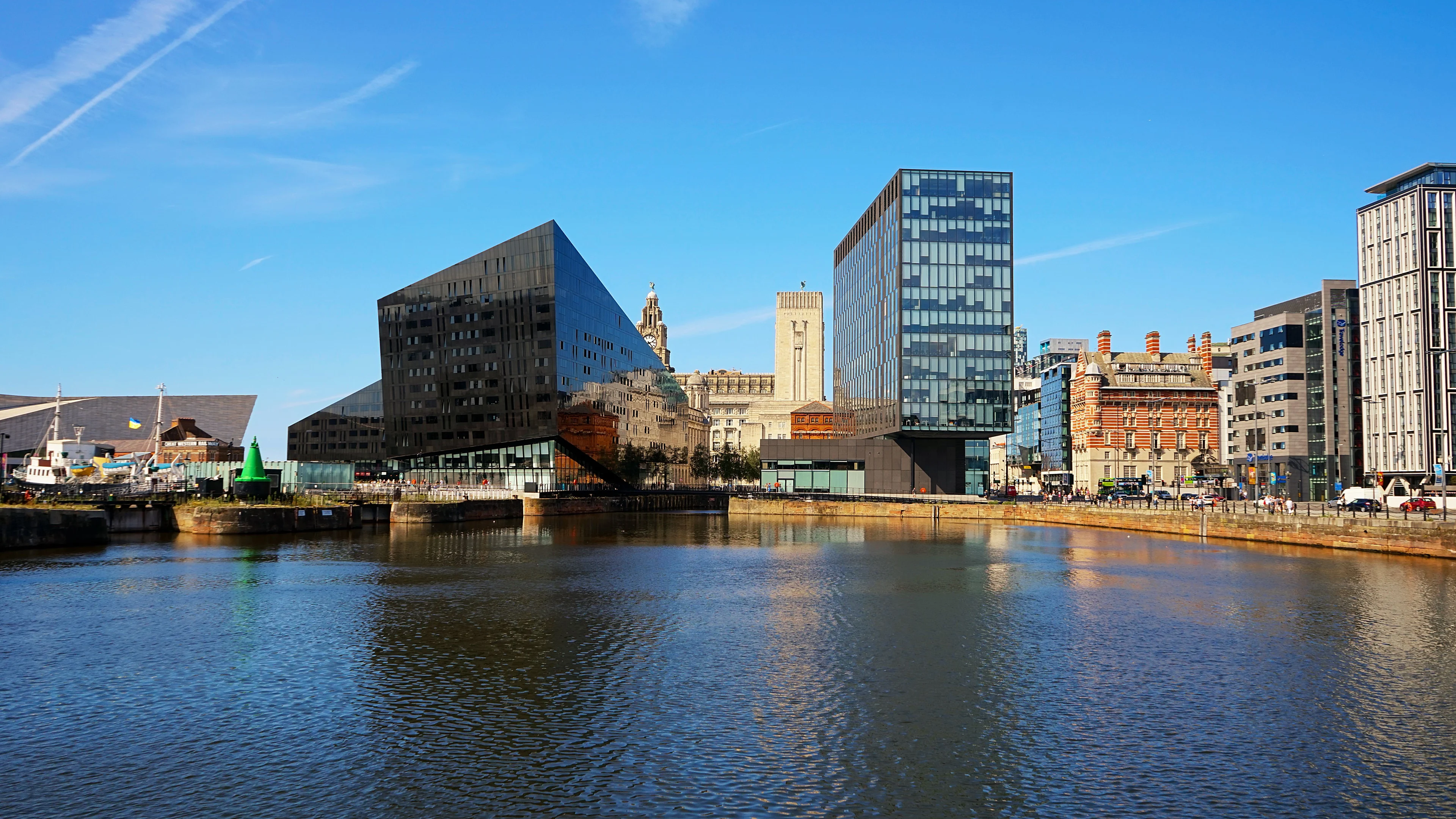 Liverpool waterfront at Mann Island with the Royal Liver Building and modern buildings reflected in the dock