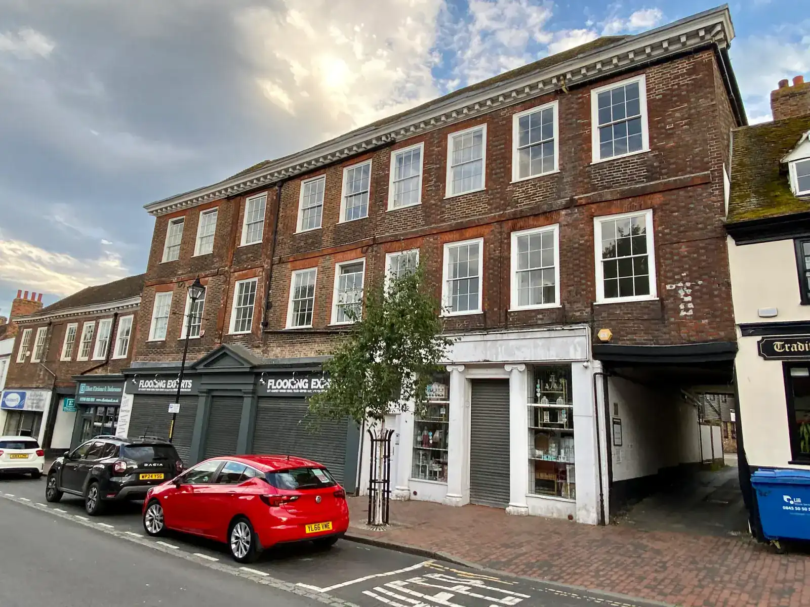 A row of Georgian brick buildings and shopfronts on Sittingbourne High Street